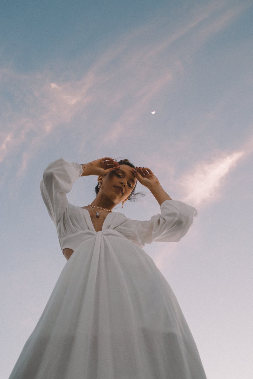 low angle photo of woman wearing white dress